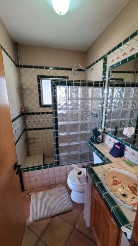 a bathroom with a toilet and a sink at Campbell's house 2nd row WiFi Las Conchas in Las Conchas