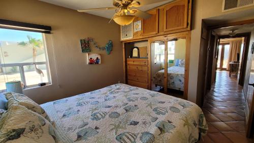 a bedroom with a bed and a dresser and a window at Campbell's house 2nd row WiFi Las Conchas in Las Conchas