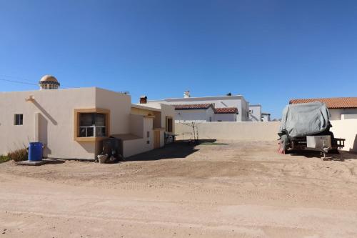 a house with a tent parked in front of it at Campbell's house 2nd row WiFi Las Conchas in Las Conchas