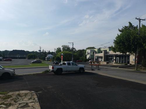 a white truck parked on the side of a street at Motel Saint-Hilaire in Mont-Saint-Hilaire