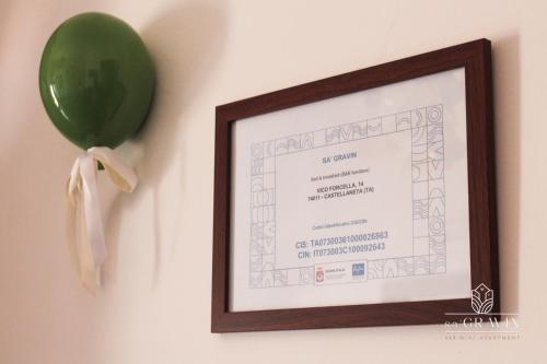 a balloon and a certificate hanging on a wall at B&B sa' GRAVIN in Castellaneta