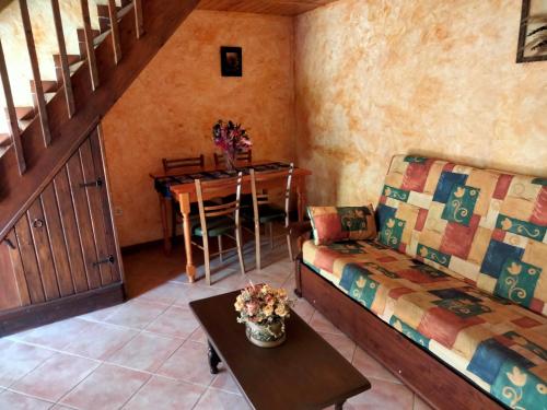 a living room with a couch and a table at Casa Rural Calzon Ordesa in Oto
