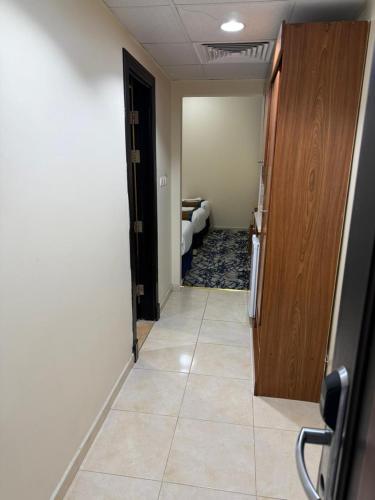 a hallway with a room with a bed and a door at فندق تارا الروضة in Makkah