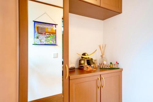 a kitchen with a door leading into a room at Shinjuku Y HOTEL II 1 minute to 7-Eleven 6DK 2 bathrooms in Tokyo