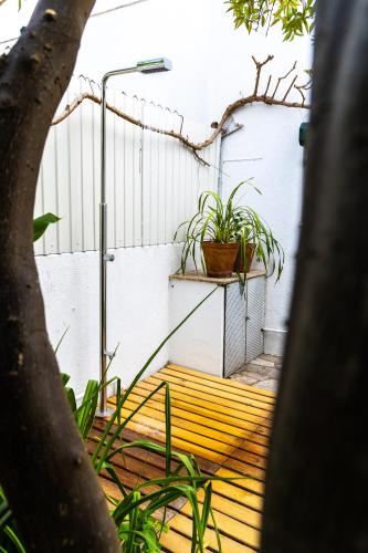 a wooden walkway with potted plants on it at Retiro das Buganvílias in Sesimbra