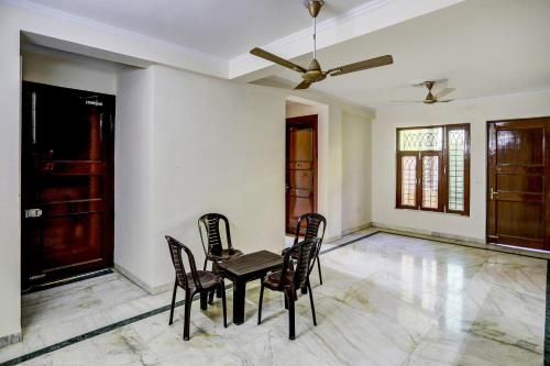 a dining room with a table and chairs at Hotel O Uk House Residency in Gurgaon