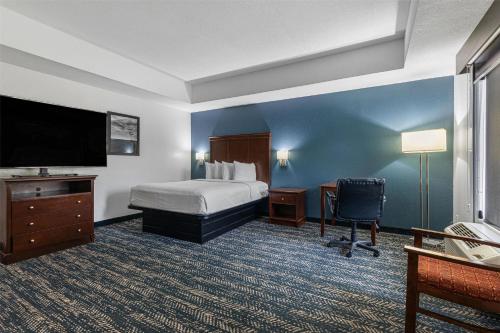 a hotel room with a bed and a flat screen tv at Best Western Canton Inn in Canton