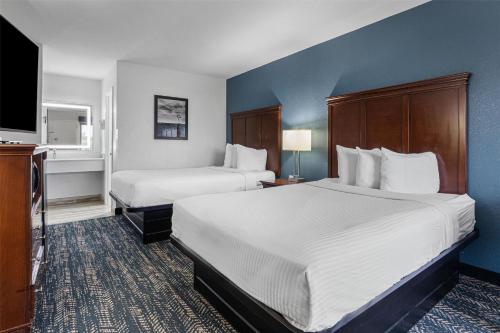 a hotel room with two beds and a flat screen tv at Best Western Canton Inn in Canton