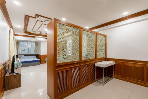 a room with wood paneled walls and a table in it at White Base in Bangkok