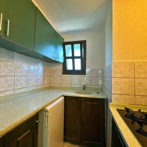 a kitchen with a sink and a stove in it at Club Mel Holiday in Ortaca