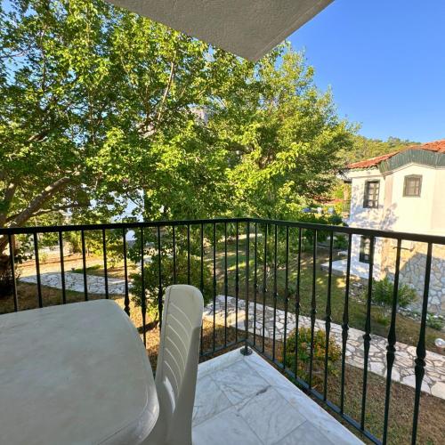 a balcony with a white chair and a fence at Club Mel Holiday in Ortaca