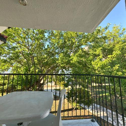 a balcony with a white chair and a fence at Club Mel Holiday in Ortaca