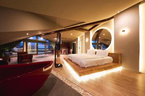 a bedroom with a bed and a large mirror at Tare Houses in Istanbul