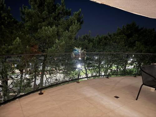a balcony at night with a fence and trees at Karo Hotel in K'obulet'i