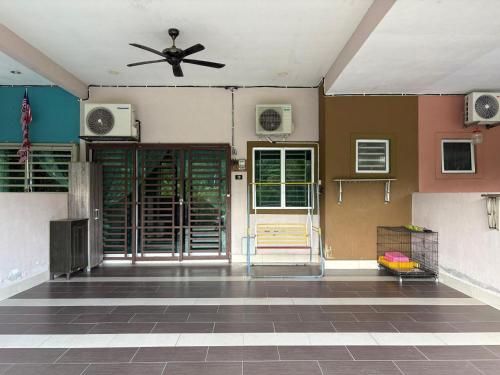 a room with a ceiling fan and a door at Homestay Sakinah No 39 in Tanjung Malim