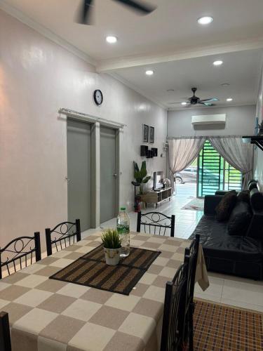 a living room with a couch and a table at Homestay Sakinah No 39 in Tanjung Malim