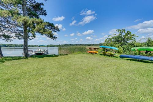 a large yard with boats on the water at Lakefront Mound Getaway Near Snowmobiling Trails! in Mound