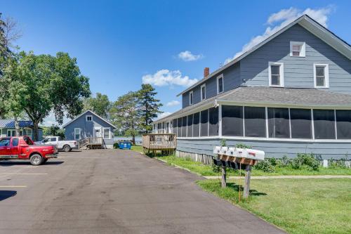 a house with a red truck parked in front of it at Lakefront Mound Getaway Near Snowmobiling Trails! in Mound