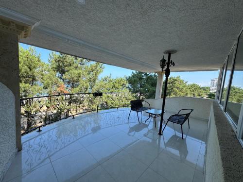 a balcony with two chairs and a table on a balcony at Karo Hotel in K'obulet'i