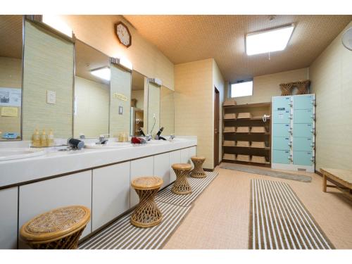 a large bathroom with two sinks and two stools at Minami Fukuoka Green Hotel - Vacation STAY 34040v in Fukuoka