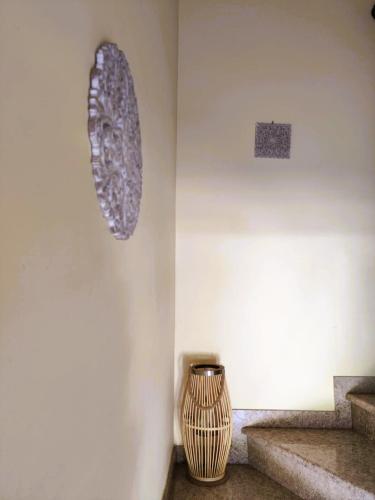 a vase sitting on a wall next to some stairs at TriΖin in Galatas