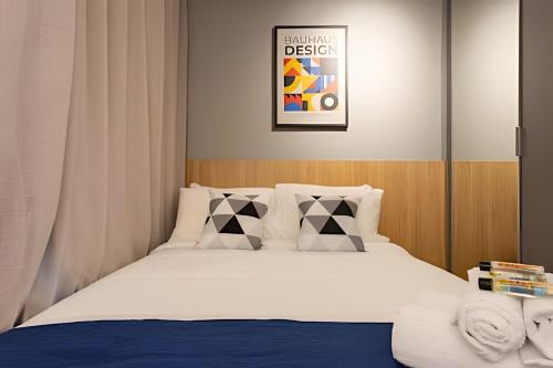 a bedroom with a bed with white sheets and pillows at Today Perdizes in Sao Paulo