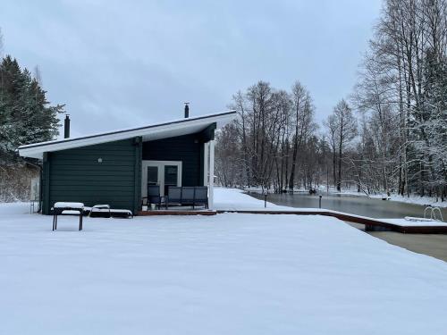 a small cabin with snow on the ground at Rabamaja ja Rabasaun in Kolga