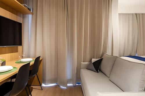 a living room with a couch and a table at Today Perdizes in Sao Paulo