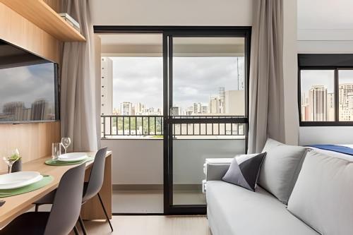 a living room with a couch and a table with chairs at Today Perdizes in Sao Paulo
