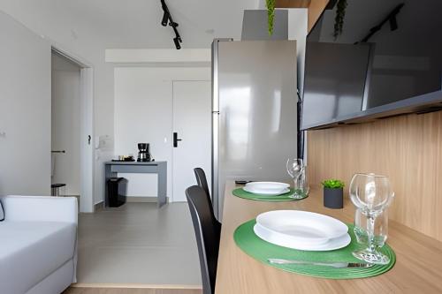 a kitchen with a table with plates and glasses on it at Today Perdizes in Sao Paulo