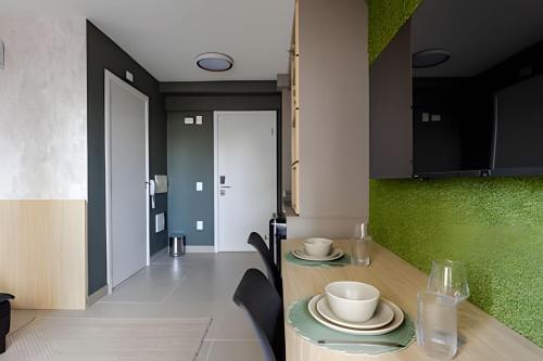 a dining room with a table with cups and plates on it at Today Perdizes in Sao Paulo