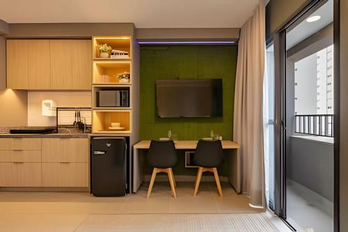 a kitchen with a table and two chairs at Today Perdizes in Sao Paulo