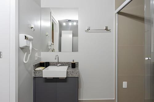 a bathroom with a sink and a shower at Today Perdizes in Sao Paulo