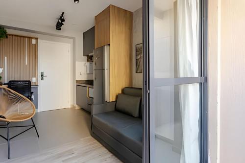 a small apartment with a couch and a kitchen at Today Perdizes in Sao Paulo
