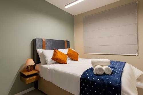 a bedroom with a bed with two towels on it at Today Perdizes in Sao Paulo