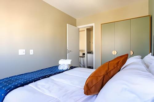 a bedroom with a large bed with white sheets at Today Perdizes in Sao Paulo