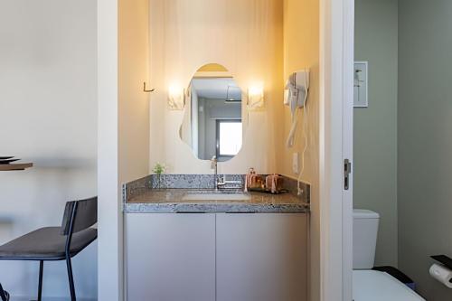 a bathroom with a sink and a mirror at Today Perdizes in Sao Paulo