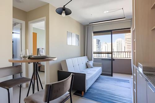 a living room with a couch and a table at Today Perdizes in Sao Paulo