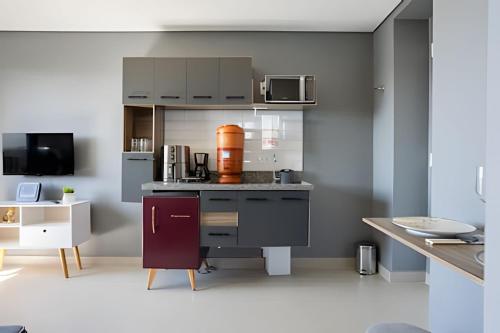 a kitchen with a counter with a coffee maker at Today Perdizes in Sao Paulo