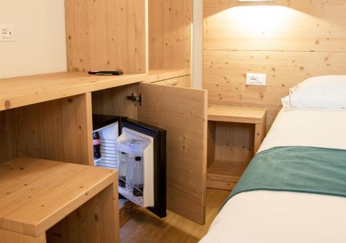a small room with a bed and wooden walls at AL Borgo in Tempio