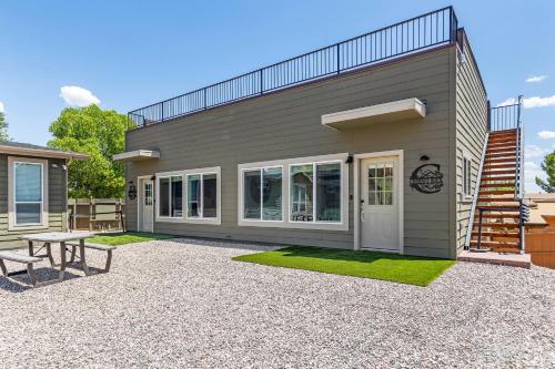 a small house with a picnic table and a patio at Chimney Rock Suite - Unit C - Red Rock Retreat in Sedona