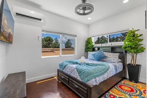 a bedroom with a bed and two windows at Chimney Rock Suite - Unit C - Red Rock Retreat in Sedona