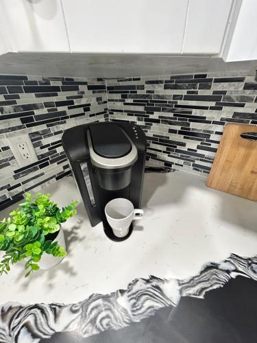 a black chair in a room with a brick wall at Grey Novo Studio + free-parking&wifi in Tampa