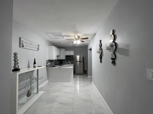 a kitchen with a ceiling fan and a refrigerator at Grey Novo Studio + free-parking&wifi in Tampa