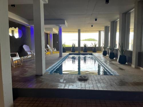 a pool in the middle of a building at Mirasoles 20 in Las Gaviotas