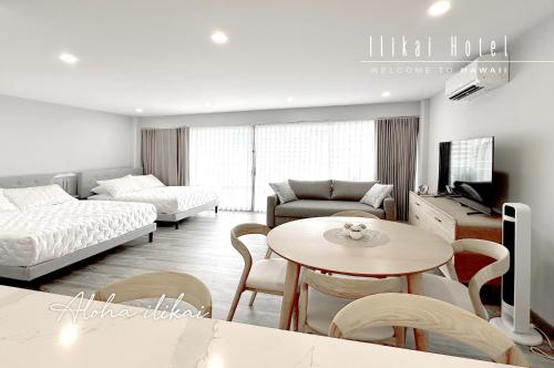 a living room with a table and a couch at New Aloha Waikiki Ilikai Hotel Condo Free Parking in Honolulu