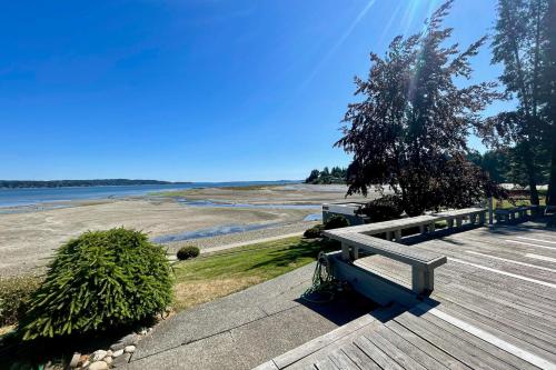 a bench sitting on top of a boardwalk near the water at Mintercreek Cabin in Gig Harbor