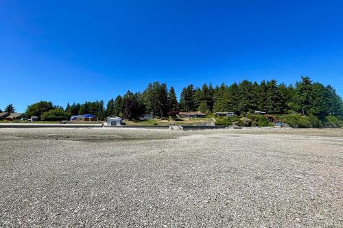 an empty parking lot with trees in the background at Mintercreek Cabin in Gig Harbor