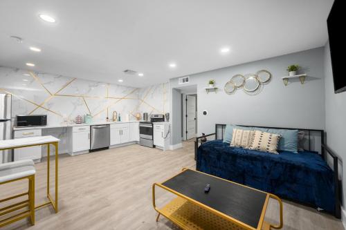 a living room with a bed and a kitchen at Hip & Quirky Montrose Flat with Pool Access & Parking in Houston