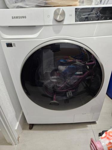 a washing machine with its door open in a room at Sunrise Haven Holiday Apartments Barbados in Christ Church